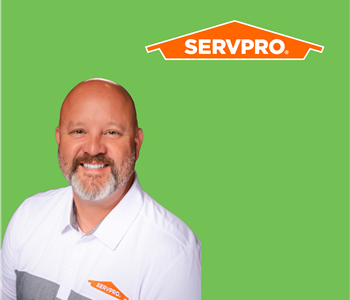 a man in front of a SERVPRO background